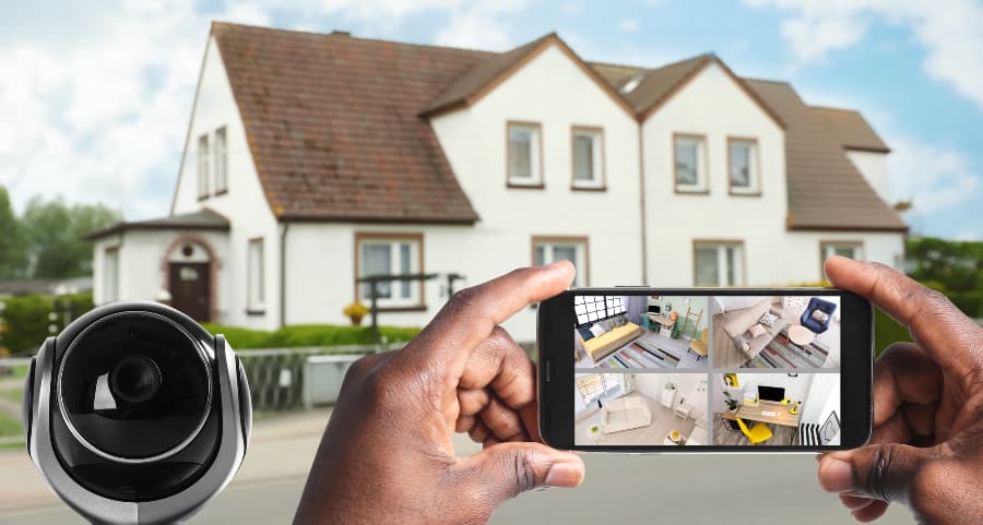 Man holding phone and viewing streams from security cameras